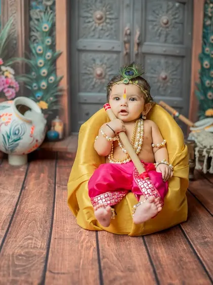 A full view of the setup with the baby Krishna in a beanbag, showing the scale of the studio set.