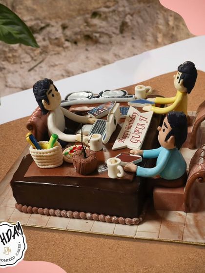 A cake for the dedicated workaholic. This incredible 3D cake depicts a busy office scene, complete with laptops, coffee mugs, and fondant figures hard at work.