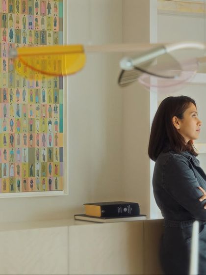 A candid shot of me in the space, reflecting on the design. The colorful artwork and kinetic mobile add a layer of personality and movement to the room.