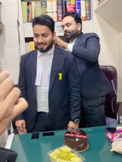 My mentor adjusting my advocate's band during the ceremony, a significant tradition.