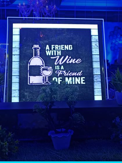 For a more relaxed vibe, this "A Friend with Wine is a Friend of Mine" sign is perfect. It helps create a warm and inviting atmosphere for guests to mingle.