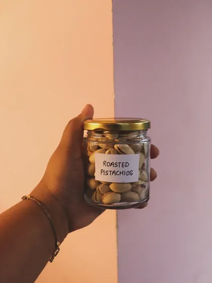 A jar of roasted pistachios, one of the savory snack options I offer in my mix-and-match hampers.