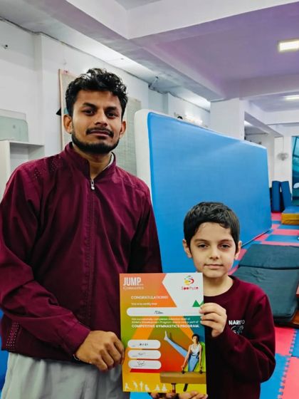This student receives his "JUMP" program certificate, marking his advancement.