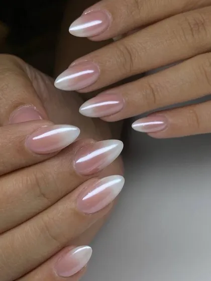 A stunning pearlescent ombré on almond-shaped nails. This 'glazed' effect over the gradient adds a trendy, high-shine finish.