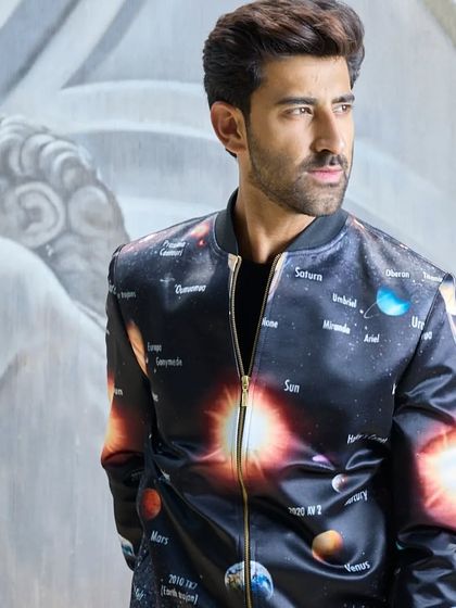 A celestial masterpiece. This satin bomber jacket features a vibrant, detailed graphic of the solar system. It is a unique piece of wearable art for the modern style enthusiast.