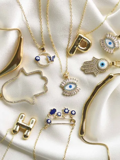Your cart looks empty. This flat lay shows off a variety of my best-selling necklaces, from the safety pin charm to the jumbo hamsa and balloon initial designs.