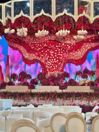 Another perspective of the grand stage, showing the elegant white seating for guests, which provides a perfect contrast to the vibrant decor.