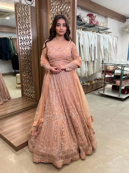 This peach-colored lehenga with all-over silver embroidery is soft, elegant, and perfect for a day event.