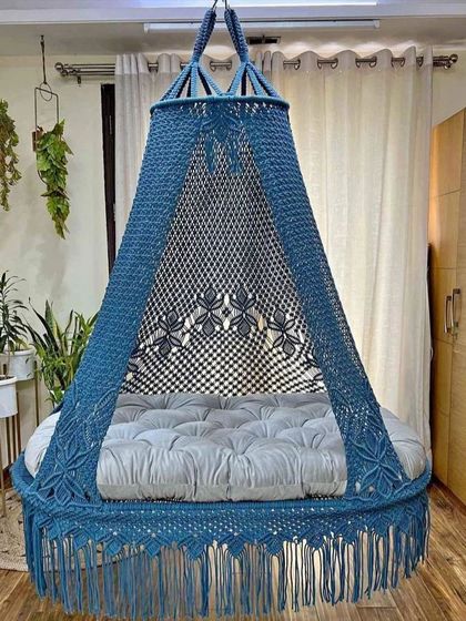 A beautiful blue dual seater swing with a grey mattress. The floral pattern on the canopy is a detail that sets our handmade swings apart.