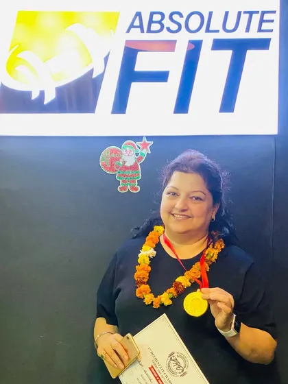 The ultimate powerhouse. Our powerlifting champion proudly displays her gold medal and certificate. She dominated the competition and took the crown, and we couldn't be prouder.