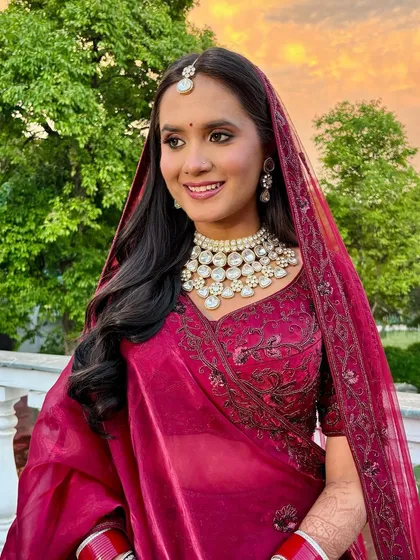 A beautiful bride against the sunset. Her makeup is designed to look stunning in the magical golden hour light.