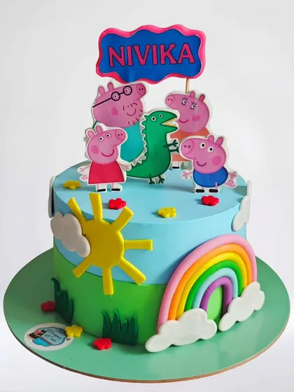 A bright and cheerful Peppa Pig cake. This whipped cream design features the whole Peppa Pig family enjoying a sunny day with a rainbow, perfect for a toddler's birthday.