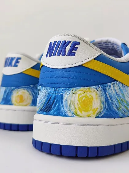 A detail shot of the heel, showing the glowing moons from "Starry Night." Even the back of the shoe is part of the canvas.