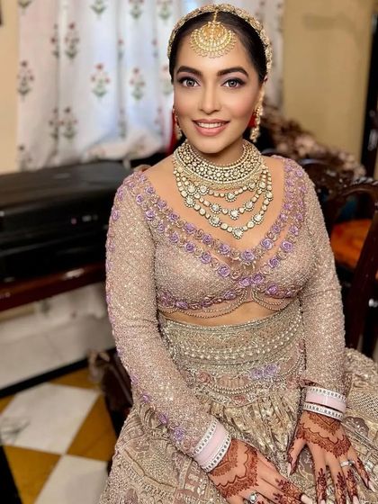 A beautiful bride ready for her big day. The mehendi on her hands is a key element of her complete bridal look.