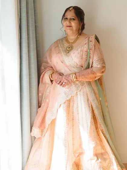 A full-length view showcasing the graceful drape of the dupatta and the soft, elegant makeup. This look is perfect for mothers who want to look polished and sophisticated.