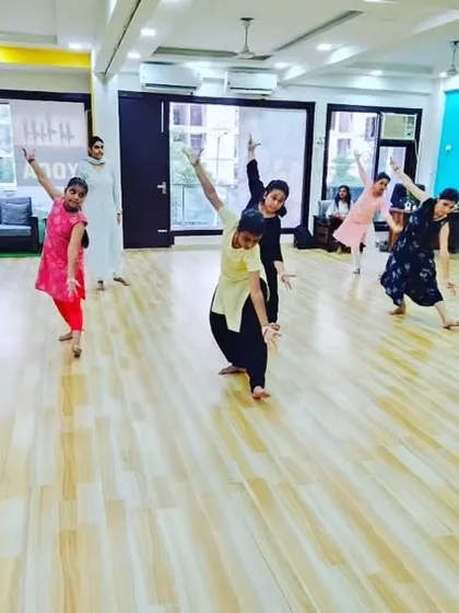 A dynamic movement from a Bharatanatyam class. The dance is not just about static poses but also about fluid transitions and energetic sequences.