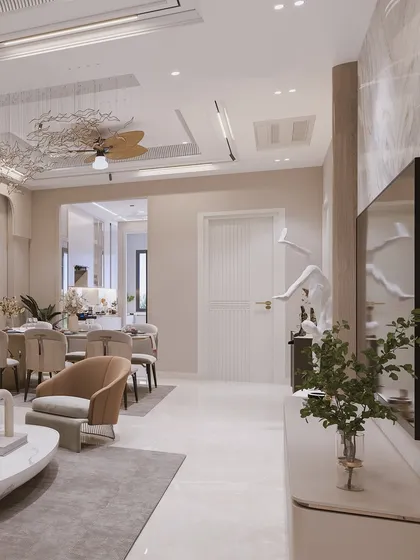 An open-plan view connecting the living and dining areas, unified by a consistent design language of soft curves and refined materials.