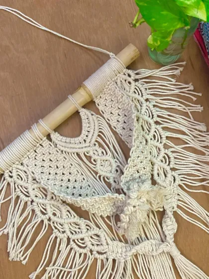 An in-progress shot of a wall hanging, showing the intricate knotwork up close. Every piece is carefully knotted by hand to ensure high quality.