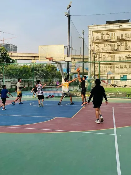 A wide view of our evening session, with multiple players engaged in a full-court game.