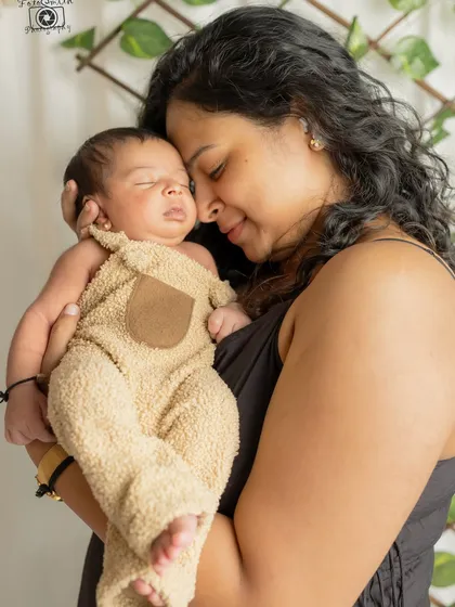 A mother's gentle embrace, a baby's peaceful sleep. I love capturing these quiet, tender moments that speak volumes about the love in the room.