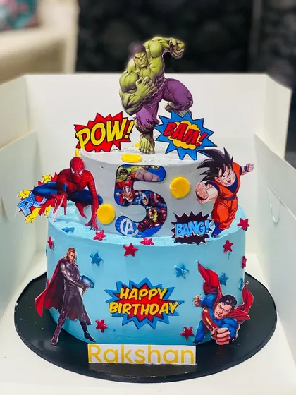 Bring the action to your party with a custom superhero cake. This two-tier Blueberry Cheesecake features favorite characters like The Hulk and Spiderman, making it a huge hit at kids' birthday parties. It's a fun and delicious way to celebrate your little hero.