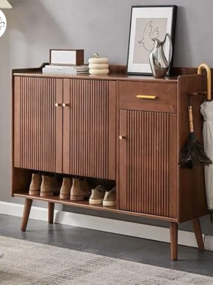 A mid-century modern style shoe rack with fluted details and an integrated umbrella stand.
