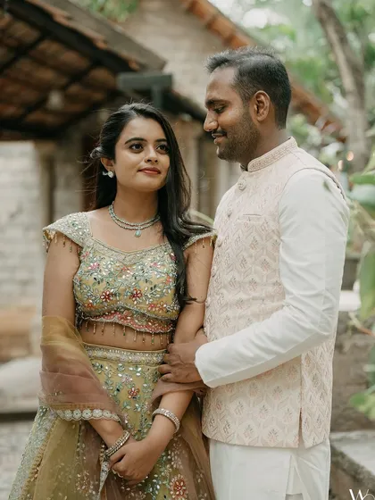 A gentle, loving portrait of a couple. The groom's hand on his bride's arm speaks of care and affection, set against the venue's stone architecture.