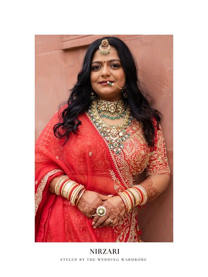 A portrait of the bride, Nirzari, showcasing her complete look, from the statement Rajasthani borla to her intricate jewellery.
