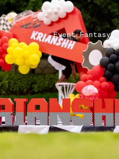 The custom "KRIANSHH" name display in checkered letters, placed in front of the main stage with a large trophy prop.