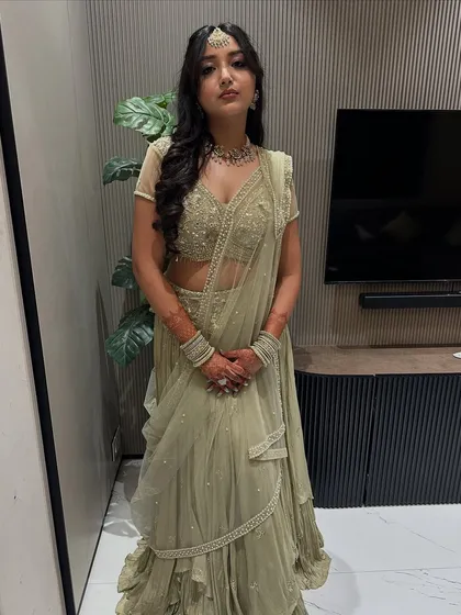 A full portrait of this bride-to-be in her muted olive lehenga. The soft makeup and hair create a sophisticated and modern look.
