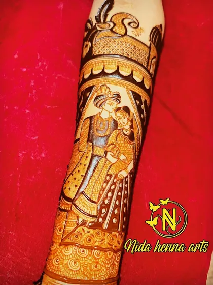 A detailed figurative design on the forearm, capturing an intimate moment between the bride and groom.