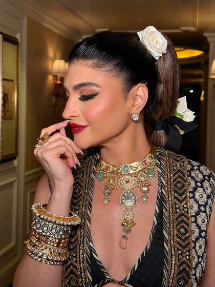 A close-up of the bold red lip and winged eyeliner. This classic combination is always a statement, exuding confidence and timeless glamour.