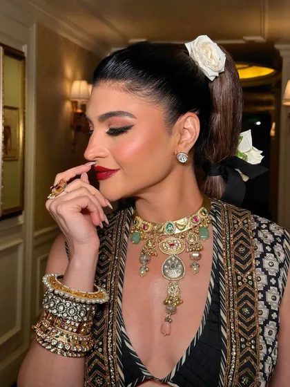 A close-up of the bold red lip and winged eyeliner. This classic combination is always a statement, exuding confidence and timeless glamour.