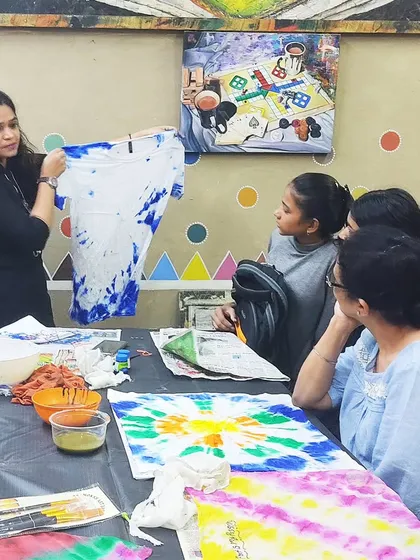 A student learning the art of tie-and-dye. Our fabric art workshops let you create your own custom-designed textiles.