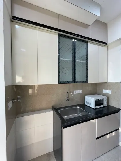 A practical utility corner with a sink and microwave, demonstrating thoughtful space planning.
