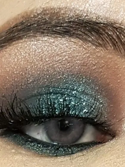 This is a teal and brown smokey eye I created on myself, seen with the eye open. This look is great for hooded eyes, as the shadow is blended upwards to create the illusion of more lid space.