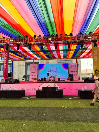 A wide shot of a colorful festival stage setup. You can see my percussion kit ready for the soundcheck.