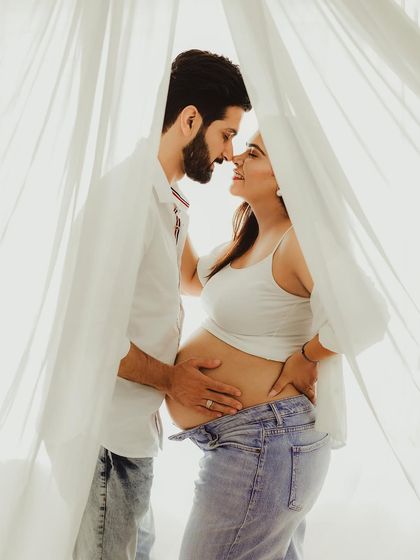 A beautiful moment of connection between the expecting parents. The casual styling and soft, natural light give this portrait an authentic and heartfelt feel.