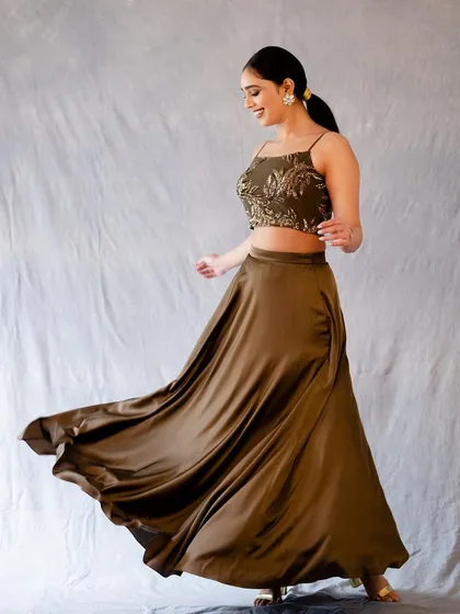 Capturing movement is key to bringing a photo to life. In this studio shot, the twirl of the satin skirt adds a dynamic and joyful element. It’s a candid moment frozen in time, showing a blend of posed elegance and spontaneous energy.