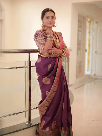 Our client Madhu looks elegant in a classic pure designer Kanchi silk saree in a deep purple shade.