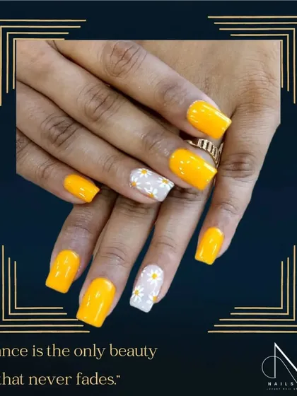 Another take on our bright yellow, this time with a transparent accent nail featuring hand-painted daisies. This shows the versatility of a single color.