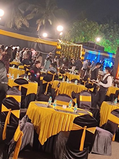 The beautiful outdoor setup for the New Year's Eve party for the Indian Coast Guard, with elegant table settings ready for the celebration.