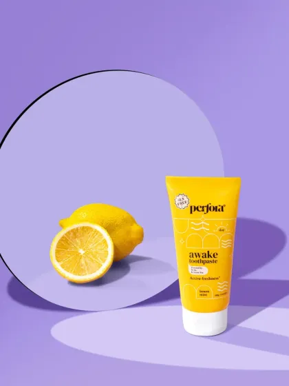 A minimalist and conceptual shot for a lemon-flavored toothpaste. We used a round mirror to reflect the fresh lemon, creating a clean, abstract composition against a soft purple background.