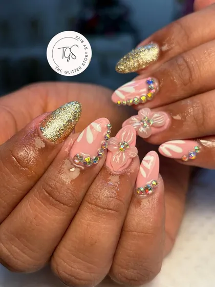 A playful and glamorous set with pink nails, hand-painted white details, 3D flowers, and a border of iridescent rhinestones for extra sparkle.