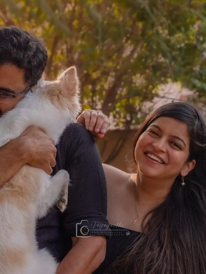 Pure happiness captured in a single frame. This couple's joyful interaction with their fluffy white dog shows the fun and energy of a family pet shoot.