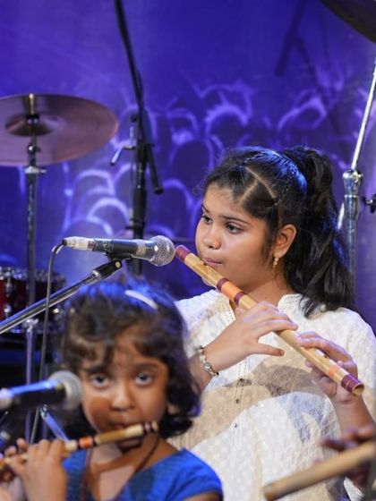 Two young bansuri students, one junior and one senior, play together during their Raag Bhupali performance.