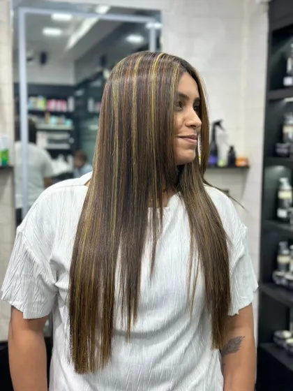 Another angle of this sleek hairstyle with expertly placed highlights. The smooth finish and clean lines showcase the precision of the cut and color service.