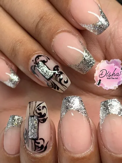 A stunning set of silver glitter French tips with intricate black and silver stamped designs.