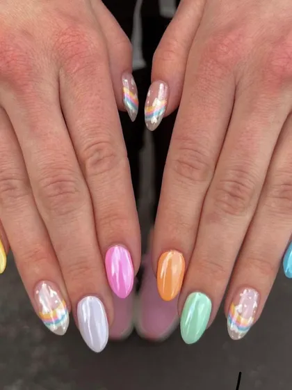 A colorful and creative set with a mix of pastel shades and rainbow patterns. This is a perfect example of a fun, customized manicure.