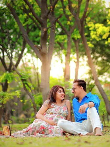 A sweet couple's picnic-style shot in the park. Their loving gaze and the casual, comfortable setting make for a very personal and intimate portrait.